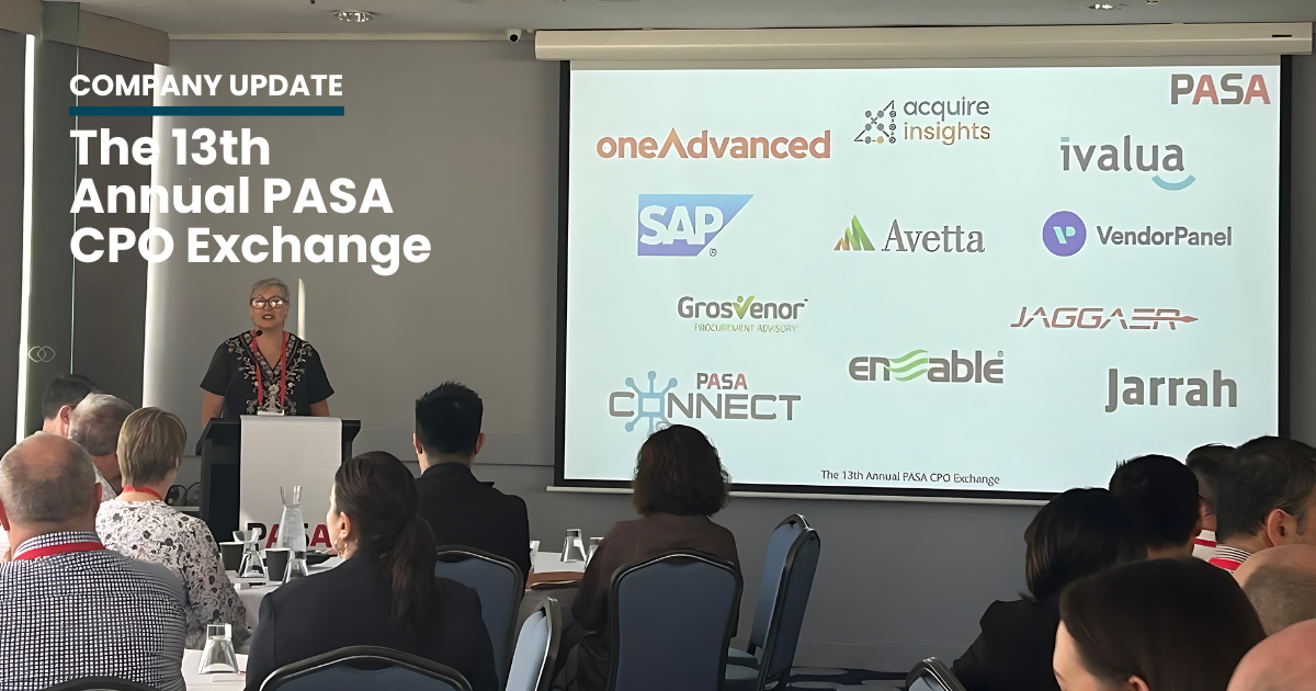 A speaker stands at a podium in front of an audience during the 13th Annual PASA CPO Exchange. Behind the speaker, a large screen displays the logos of various companies. The room is filled with attendees seated at tables, listening to the presentation.